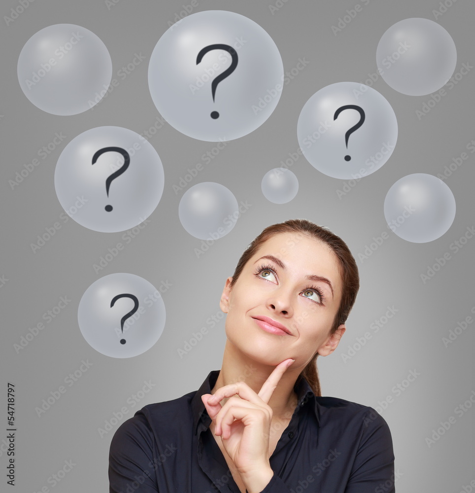 Thinking smiling woman looking up on many questions mark in bubb Thinking smiling woman looking up on many questions mark in bubb