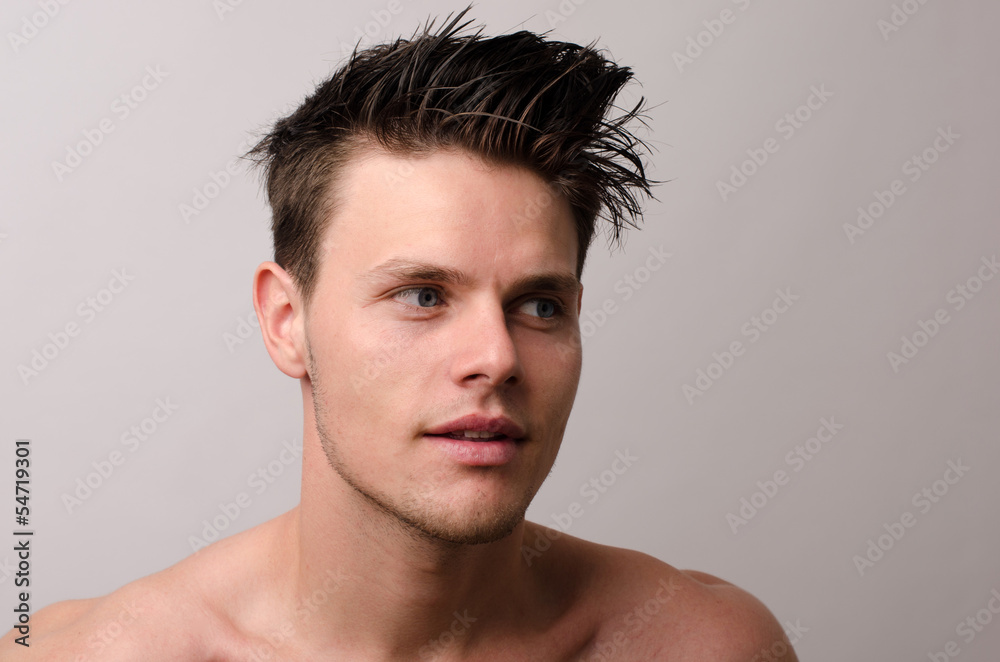 Obraz premium Portrait of a beautiful man posing fashion in a studio