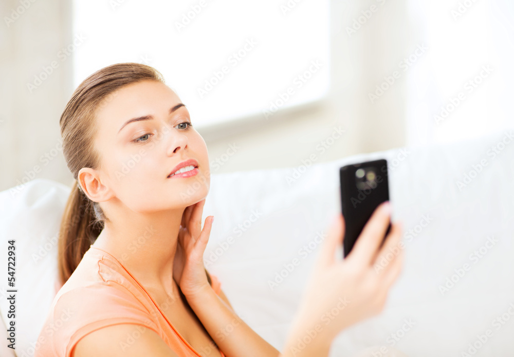 woman making self portrait with smartphone