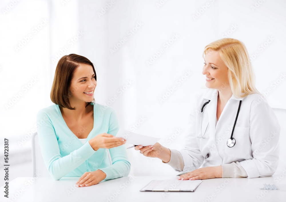 doctor giving prescription to patient in hospital