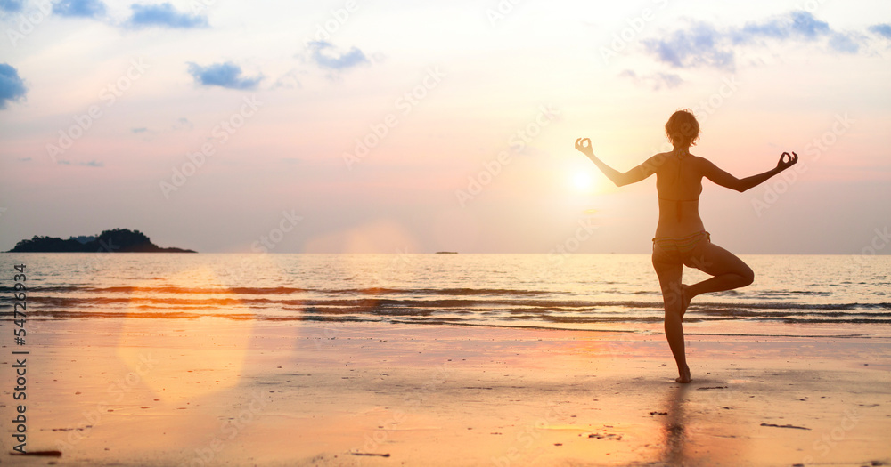 Yoga woman on the beach during sunset (in bright colors)