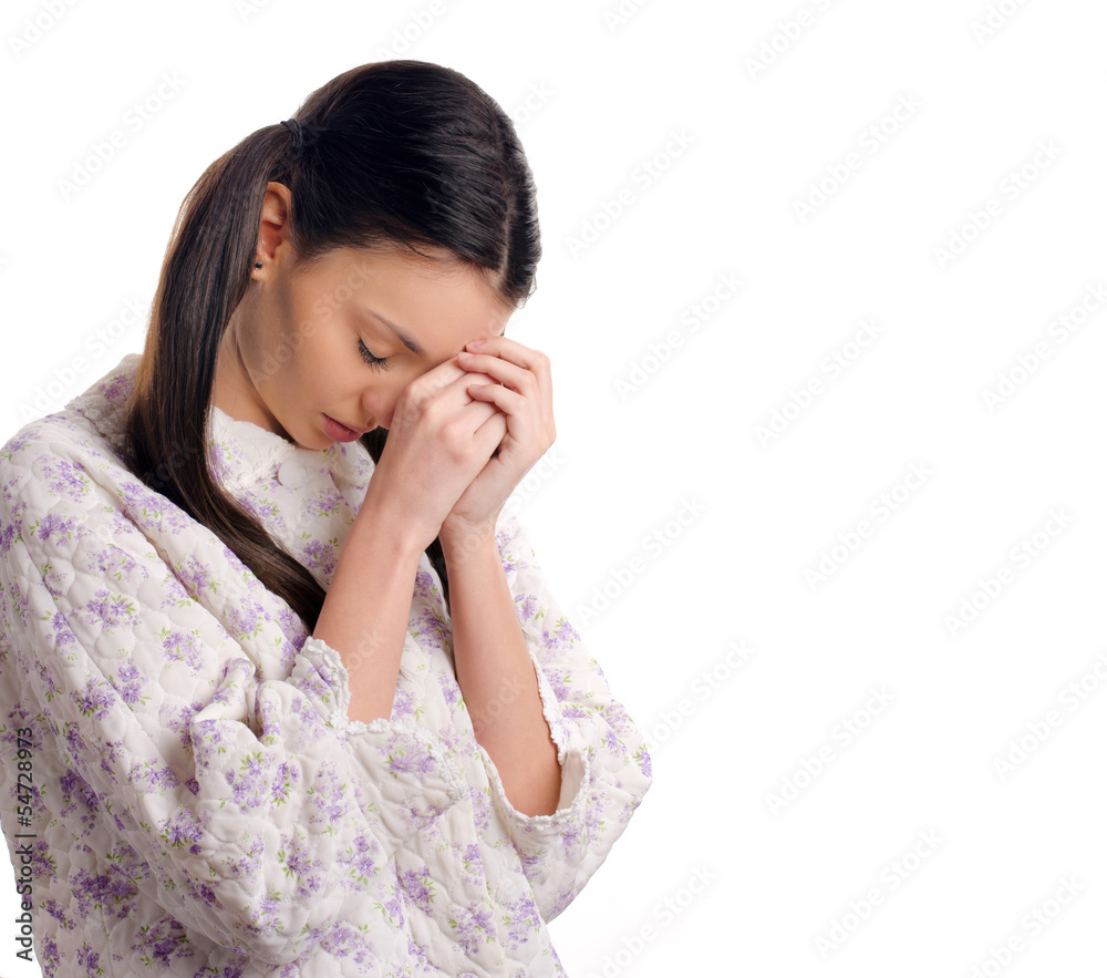 Beautiful girl in pajamas praying before bedtime. Beautiful girl in pajamas praying before bedtime.
