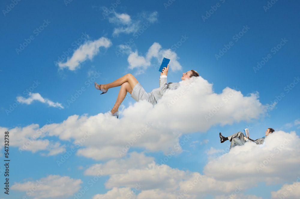 Business people lying on clouds
