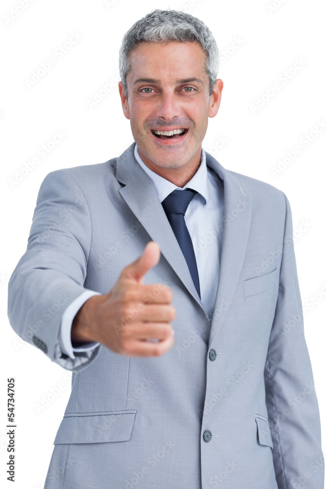 Cheerful businessman looking at camera reaching for handshake Cheerful businessman looking at camera reaching for handshake