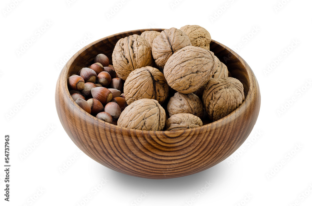 walnuts and hazelnuts in a wooden bowl on a white background walnuts and hazelnuts in a wooden bowl on a white background