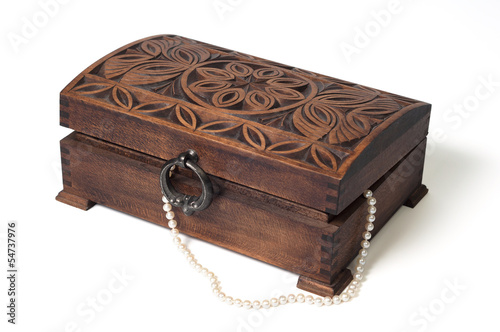 Wooden box with ornaments and a pearl necklace