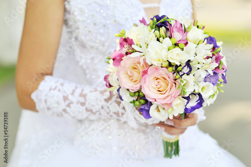 Bride is holding a wedding bouquet