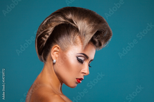 Charming woman with unusuall hairstyle looking down