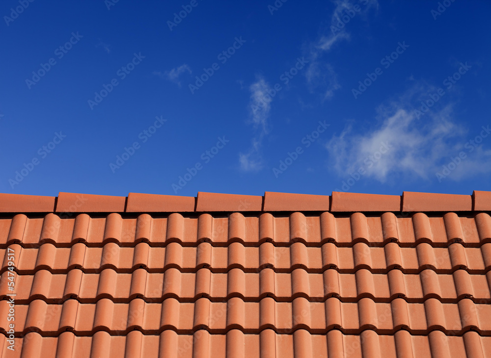 Roof tiles against blue sky