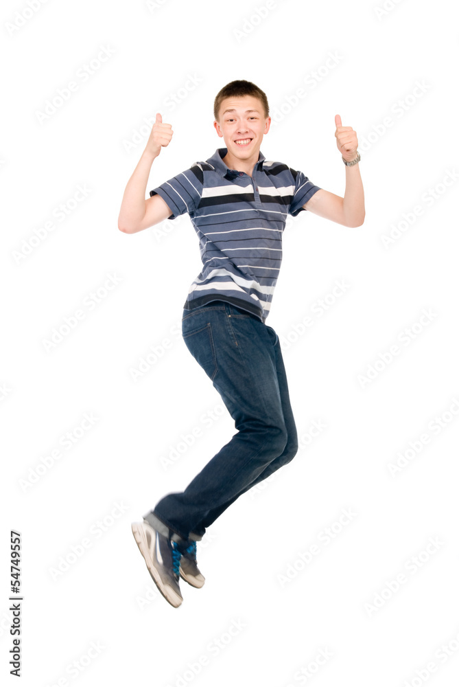 Young man jumping with raised thumbs up.