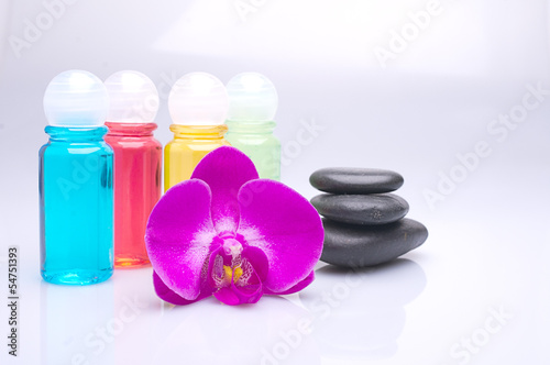 Massage stones and orchid on a white background