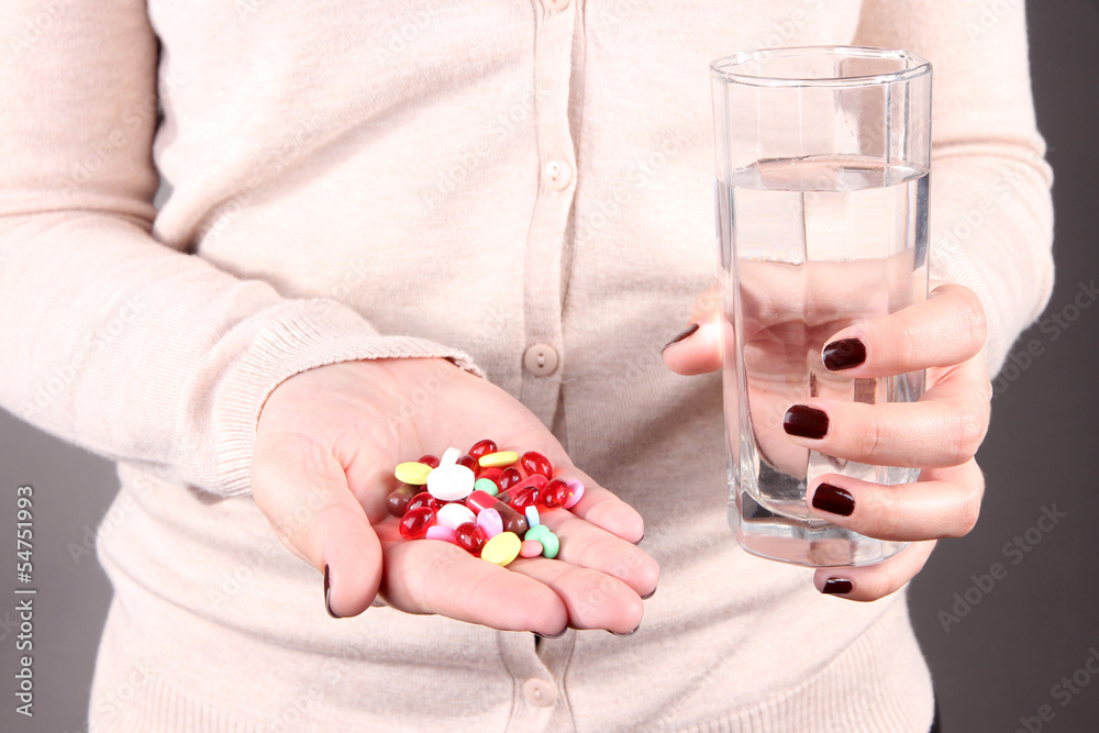 Many pills and glass water in hand Many pills and glass water in hand