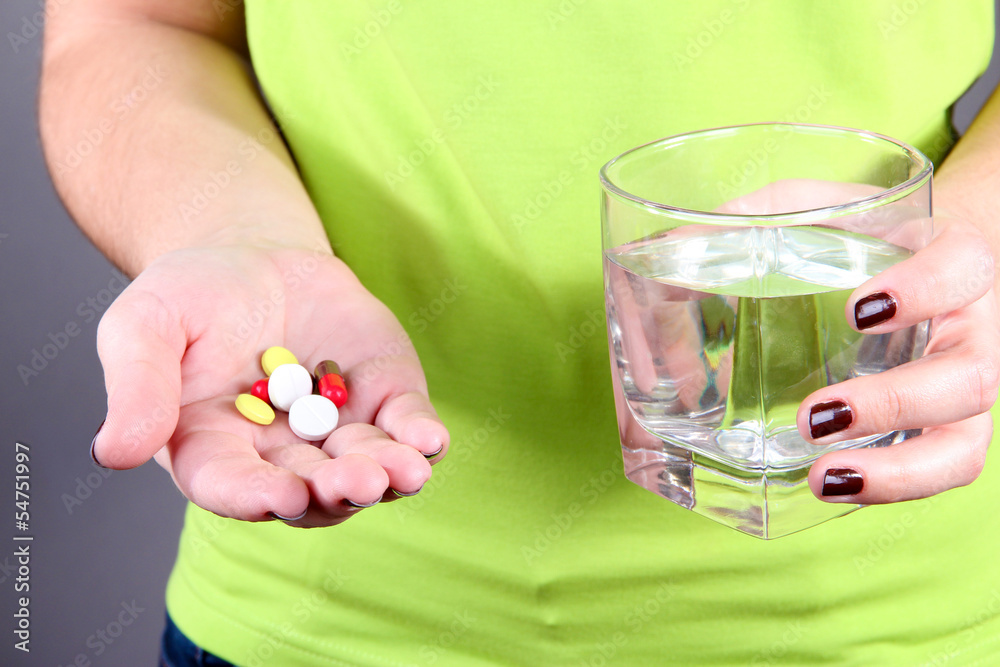 Many pills and glass water in hand Many pills and glass water in hand