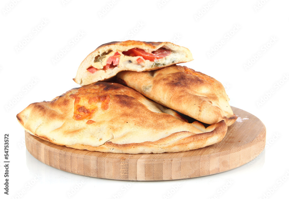 Pizza calzones on wooden board isolated on white