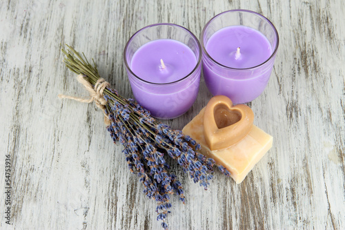 Fototapeta Naklejka Na Ścianę i Meble -  Lavender candle with fresh lavender, soap on wooden background