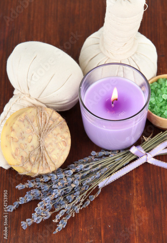Still life with lavender candle  soap  massage balls  bottles 