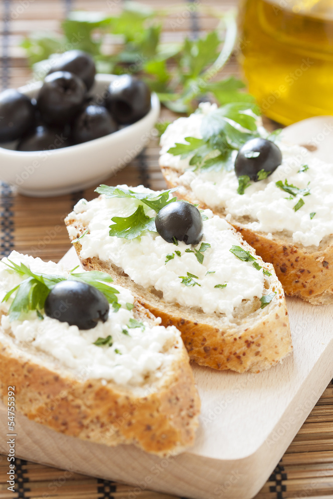 Crostini with cottage cheese, parsley and olive