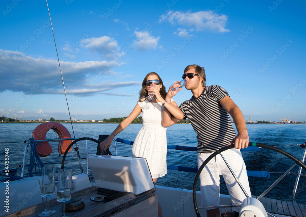 Happy young couple relaxing on a yacht