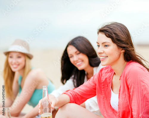 girls with drinks on the beach