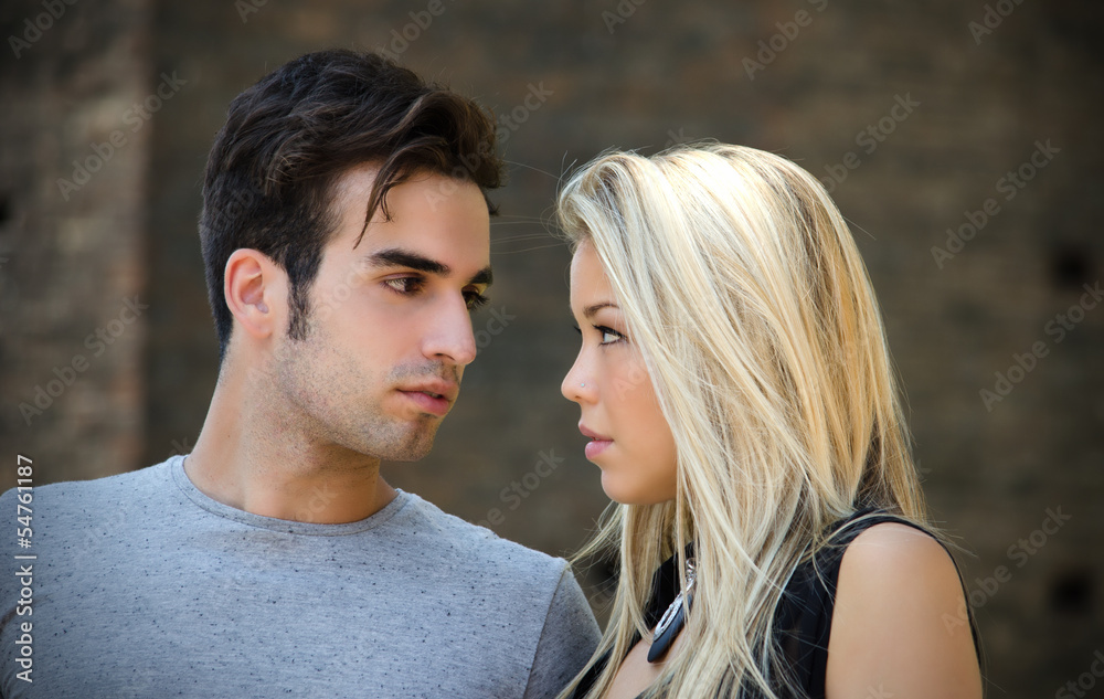 Attractive couple in love looking into each other's eyes Attractive couple in love looking into each other's eyes