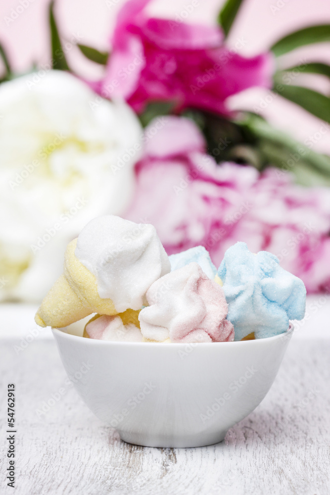 Marshmallows in white ceramic bowl. Stunning pink peonies