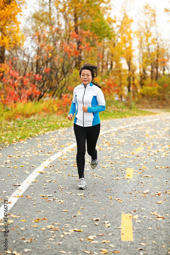 Middle aged Asian woman running active in her 50s © Maridav
