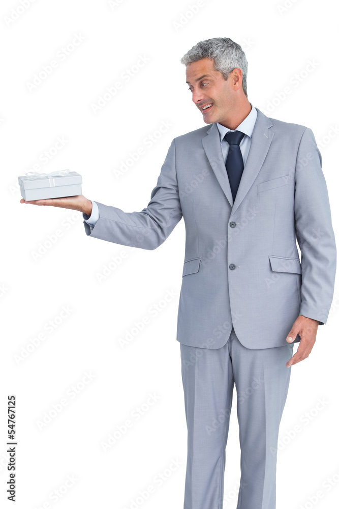 Handsome businessman holding gift on right hand Handsome businessman holding gift on right hand