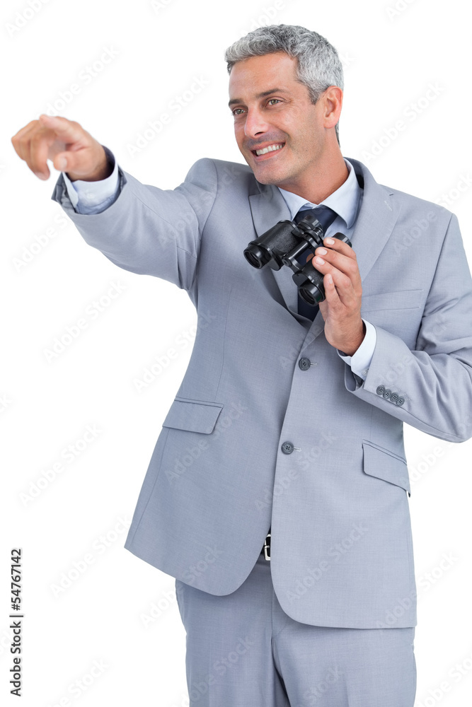 Businessman holding binoculars and pointing out something Businessman holding binoculars and pointing out something
