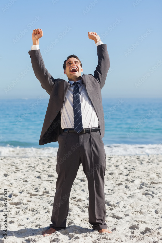 Victorious businessman in suit holding arms up Victorious businessman in suit holding arms up
