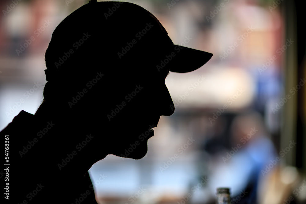 Fototapeta premium Male in baseball cap, silhouette
