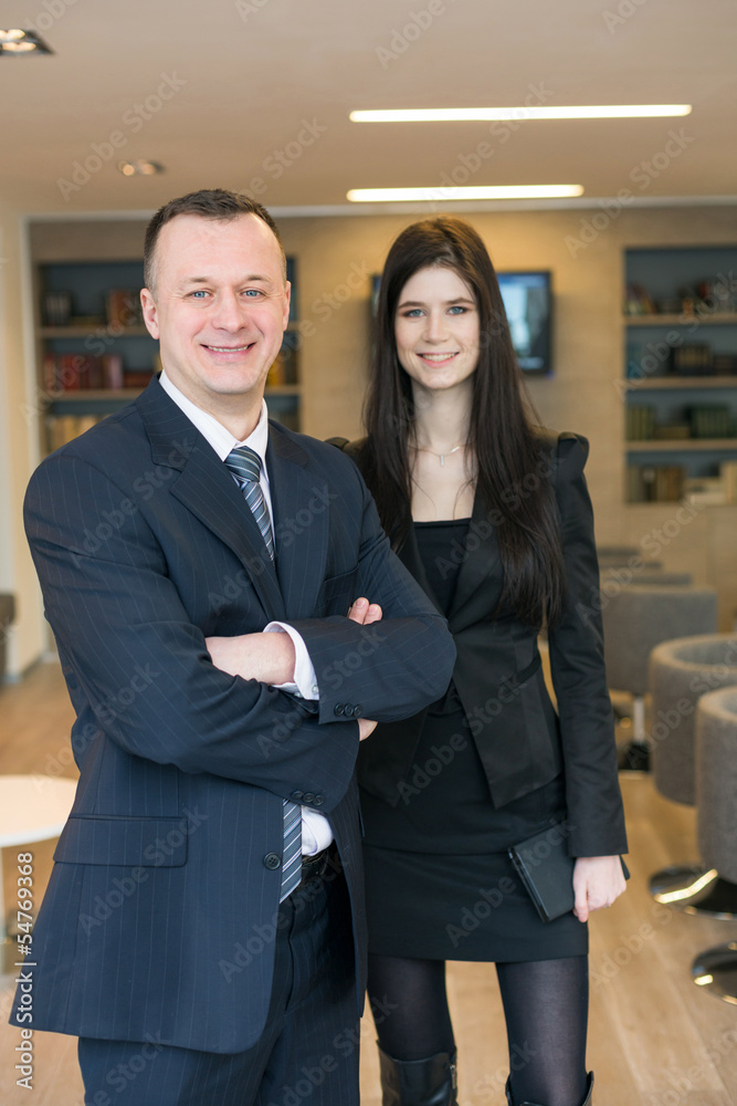 girl with man in business suits standing in the room girl with man in business suits standing in the room