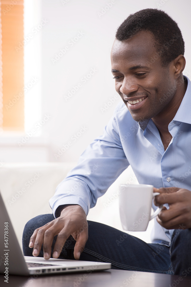 Working at the computer. Cheerful African descent men working at Working at the computer. Cheerful African descent men working at
