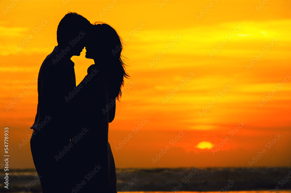 couple in love on the ocean beach at sunset
