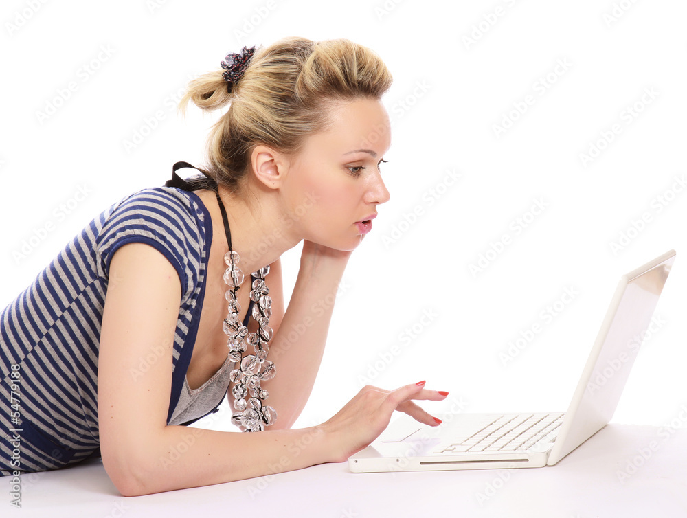 Portrait of beautiful young woman lying on floor with a laptop Portrait of beautiful young woman lying on floor with a laptop