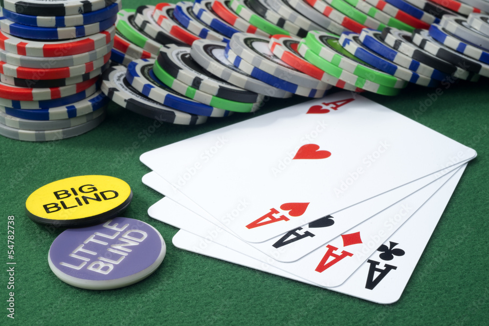 Four aces and chips on a green felt Four aces and chips on a green felt
