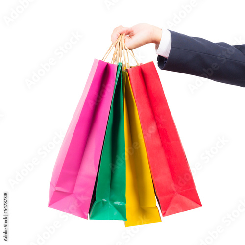hand holding colorful shopping bags