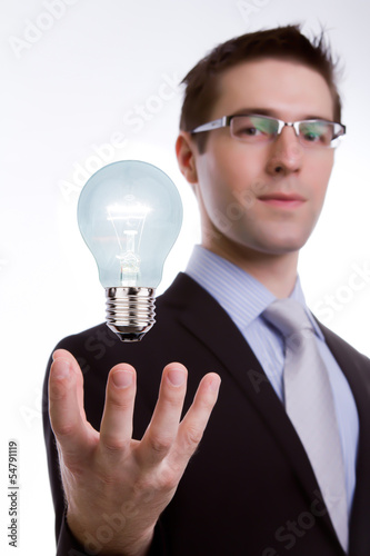 Portrait of young business man holding a light bulb