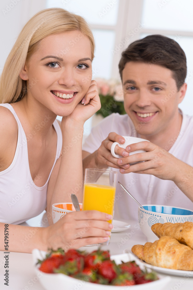Having breakfast together. Young loving couple having breakfast Having breakfast together. Young loving couple having breakfast