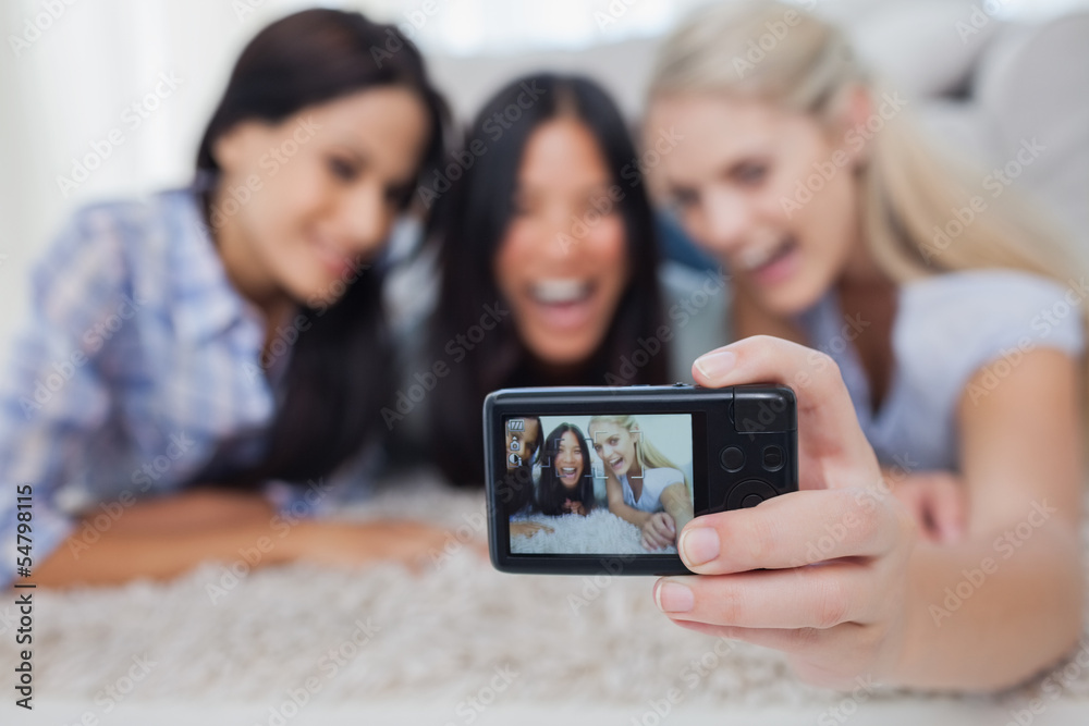 Friends lying on floor and taking a self picture