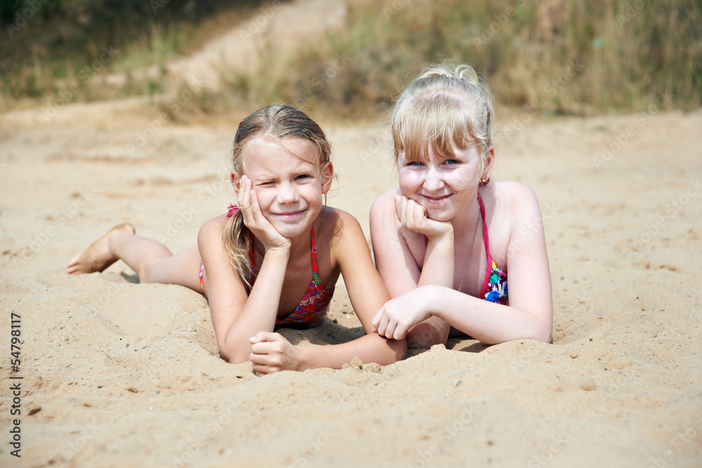 Happy little girls on sand beach Happy little girls on sand beach