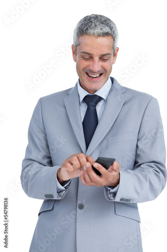 Happy businessman sending text message © WavebreakmediaMicro