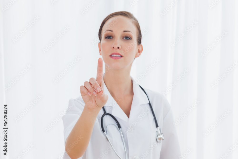 Concentrated nurse posing pointing at something Concentrated nurse posing pointing at something