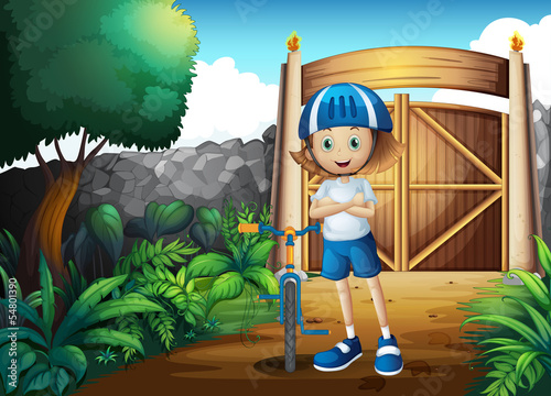 A young girl and her bike inside the gate