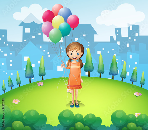 A girl holding balloons in the city