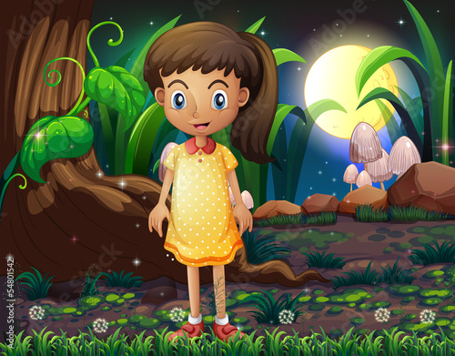 A little girl in the forest wearing a yellow dotted dress