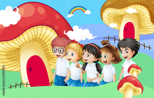 Five students near the giant mushroom houses