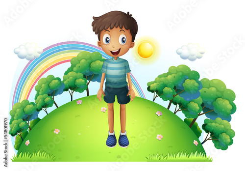 A boy standing in the middle of the hill