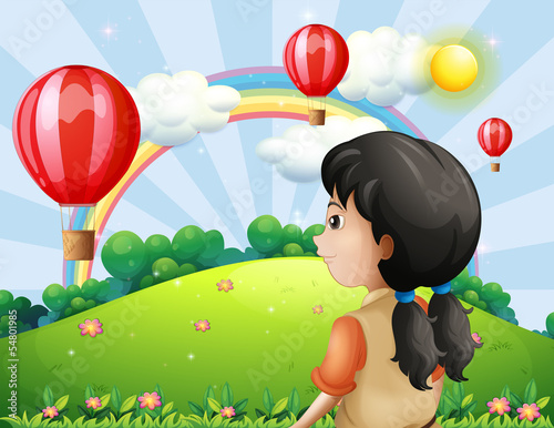 A girl looking at the hot air balloon