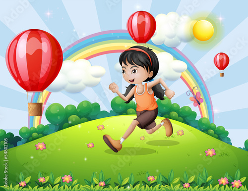 A girl running at the hilltop