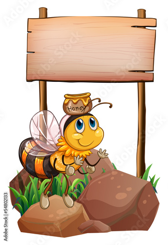 A bee above the rock near the empty signage